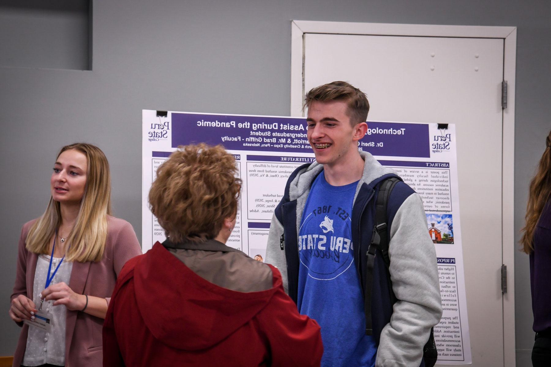 male student presenting a poster